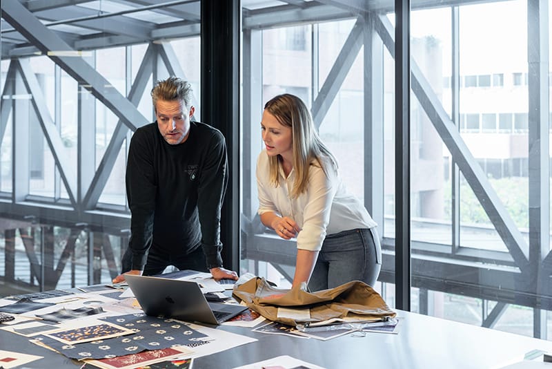 A man and woman working together at the office